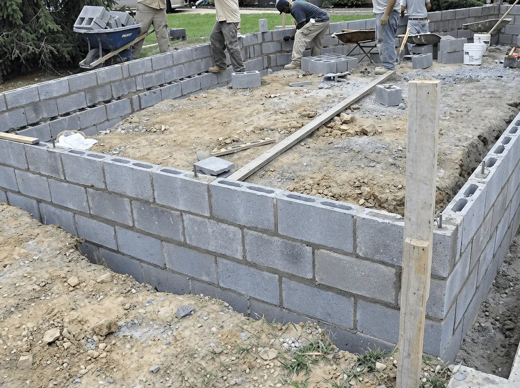 Professionals building a foundation with blocks in Bloomington, IN