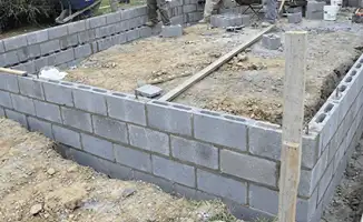 Professionals building a foundation with blocks in Bloomington, IN